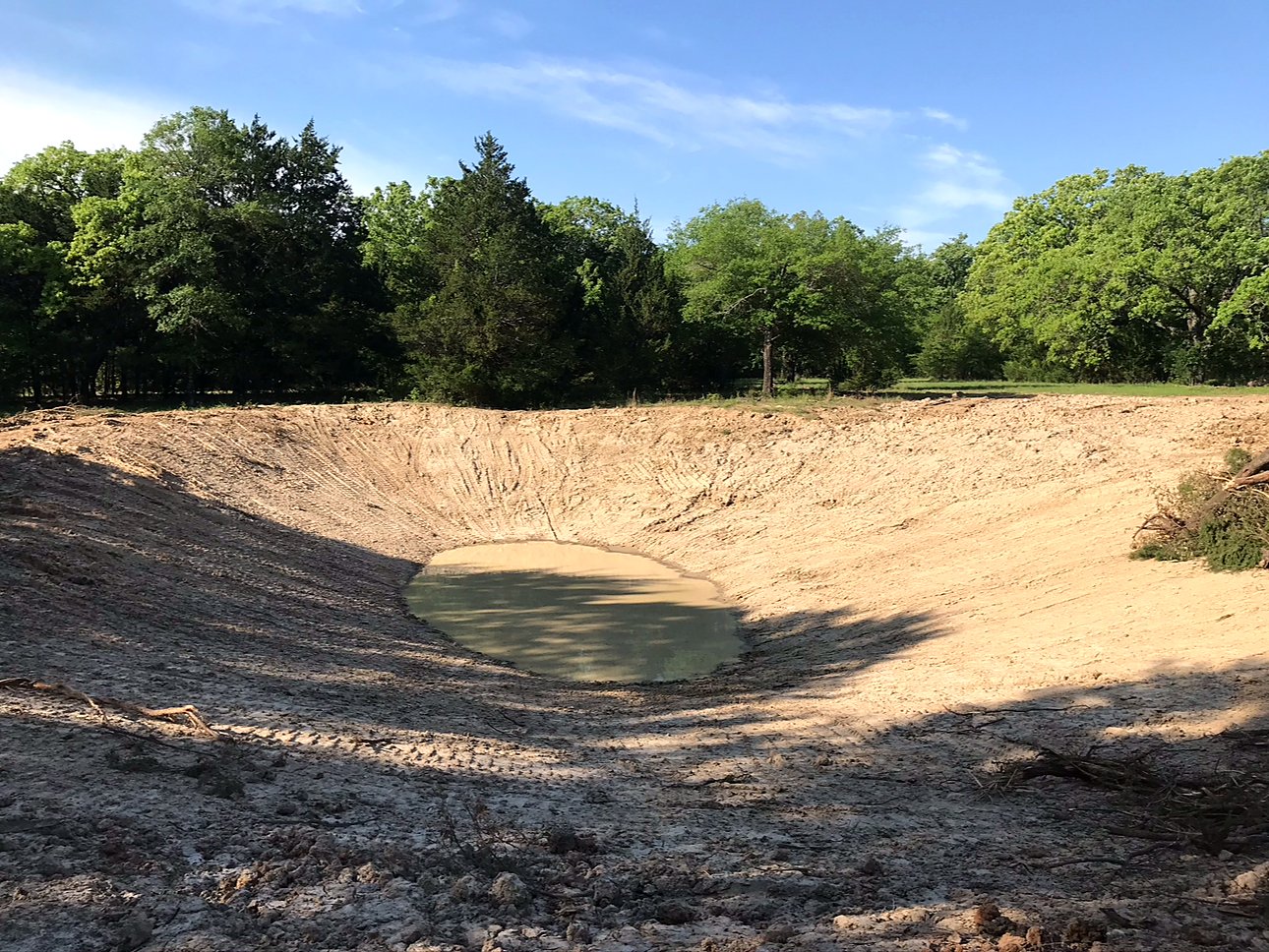 Excavated pond or pit with graded dirt banks