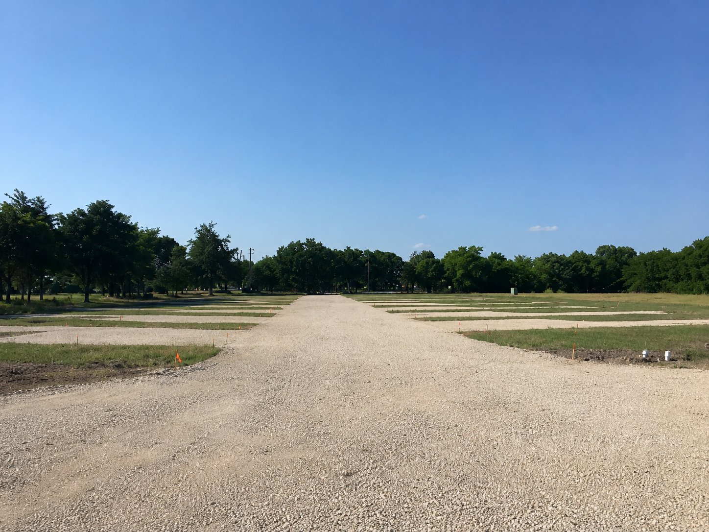 RV pads and graded gravel access road with utility hookups