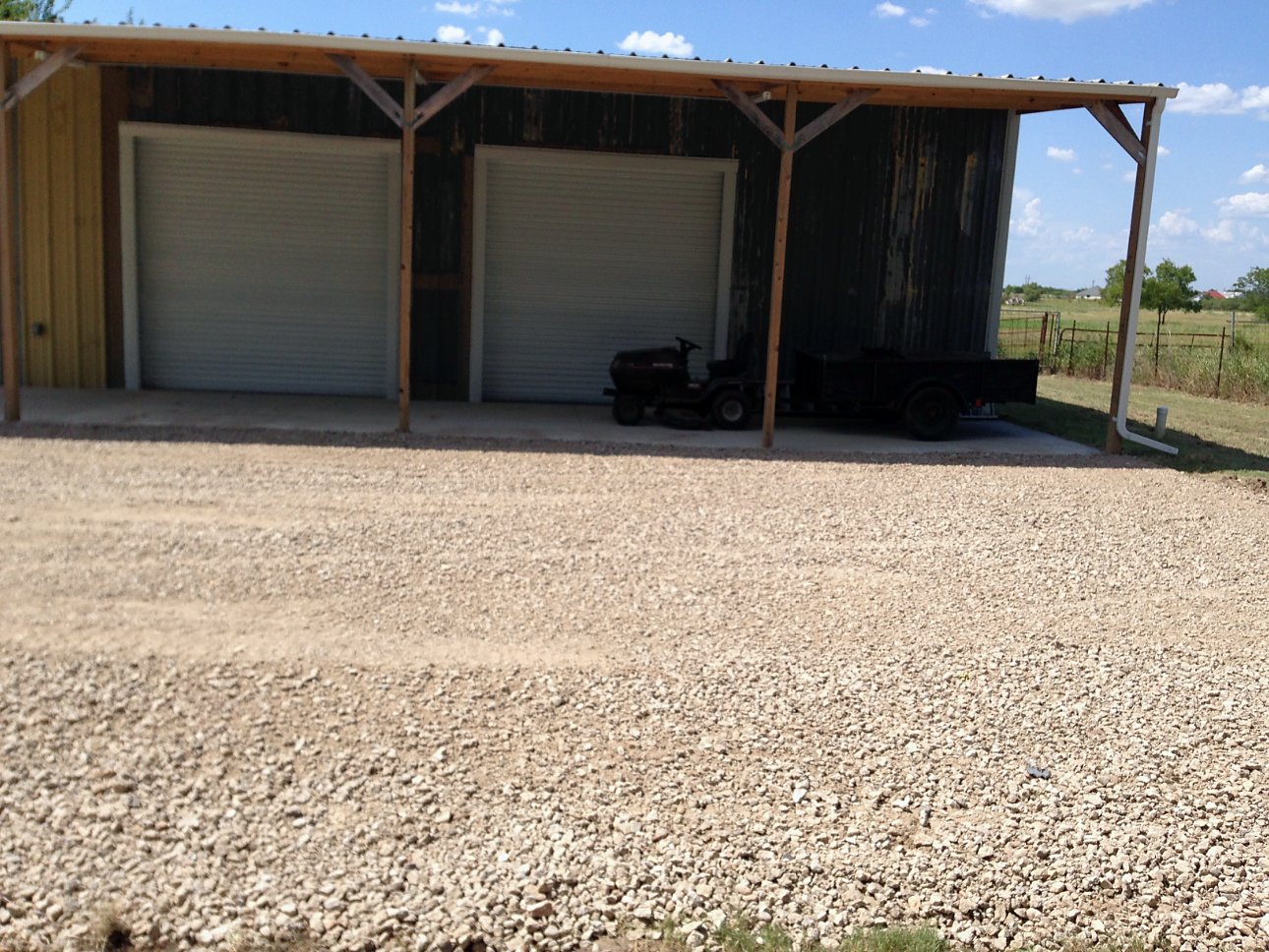 Finished gravel pad and driveway at a metal shop building